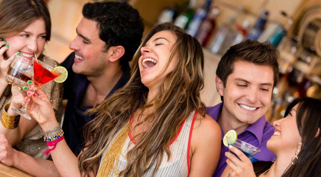 group-of-men-and-women-smiling-and-drinking.jpg